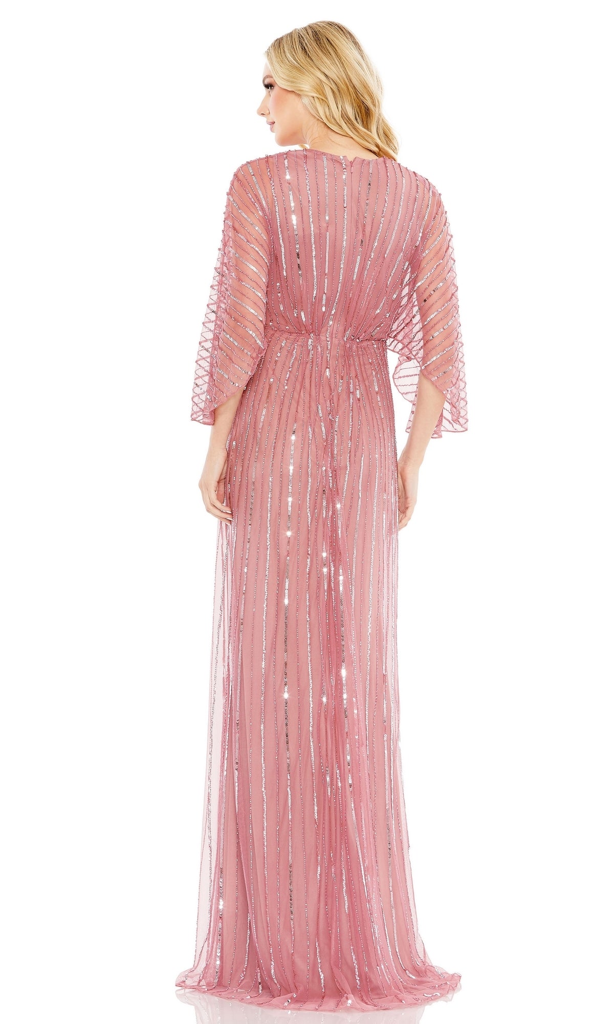 A woman with long blonde hair models the Mac Duggal 93841 Long Sequin A-Line Formal Dress, a floor-length pink gown with sheer fabric and sequin stripes, viewed from the back against a white background.